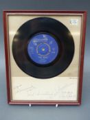 A framed 'I'm A Boy' 45rpm by The Who on the Reaction label with a signed card.