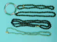 Four jade/ jadeite beaded necklaces and a silver and jadeite bangle