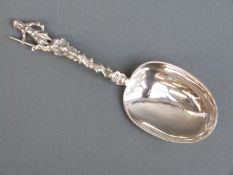 A possibly 18thC French white metal spoon topped by a huntsman,