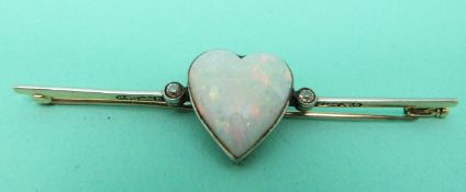 A Victorian brooch set with a heart shaped opal cabochon and two diamonds