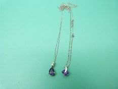 Two 9ct white gold chains and two 9ct white gold pendants one set with an amethyst,