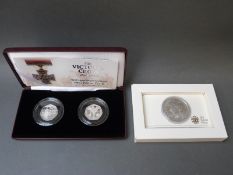 A boxed 2010 Royal Mint silver Britannia together with a pair of cased 2006 silver proof Victoria