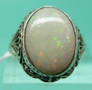 A white metal ring set with a large oval opal cabochon (Size K)