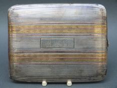 An American Elgin white metal cigarette case marked 14k gold on sterling silver,