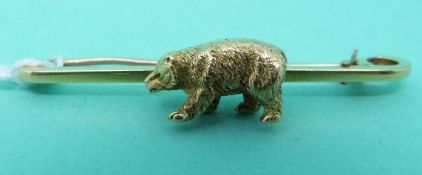 A yellow metal brooch marked 15ct set with a bear