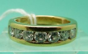 An 18ct gold ring set with seven round brilliant cut diamonds (Size J)