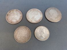 A George III crown together with two Canadian silver dollars,