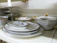 An extensive Limoges dinner service including tureens, cake plates & 33 dinner plates,