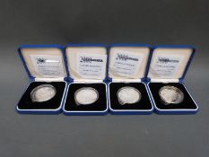Four cased silver Millennium £5 coins with certificates