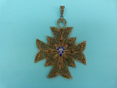 A silver gilt large filigree pendant in the form of a Maltese cross with blue and white enamel