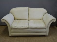 A pair of two seater sofas and a matching pouffe