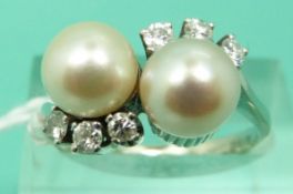 A 14ct white gold ring set with two pearls and six diamonds in a twist setting (Size Q)