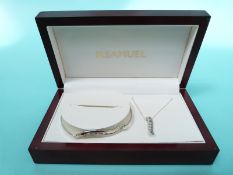 A silver pendant and bangle set with cubic zirconia
