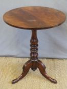A 19thC mahogany table raised on a turned column and tripod base, diameter 57,