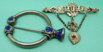 A silver brooch reading 'mum' set with four rubies and a silver kilt pin set with blue enamel.