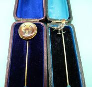 A stick pin depicting a fox's head and silver stick pin in the form of a pheasant set with enamel