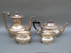 A George V Mappin & Webb hallmarked silver four piece tea service with embossed decoration,
