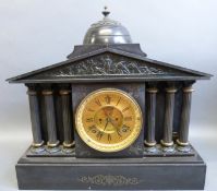 Victorian slate mantel clock in Romanesque style with triple columns either side and frieze