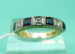 An 18ct gold ring set with alternating square cut sapphires and round cut diamonds (Size O)