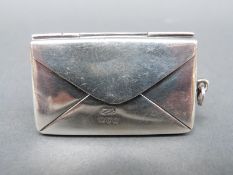 An Edward VII hallmarked silver novelty double stamp case formed as an envelope, Chester 1904,
