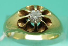 A yellow metal ring set with a round cut diamond (Size M)