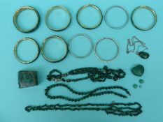 A collection of malachite bangles, malachite beads,
