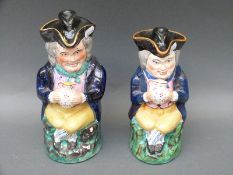 A pair of Staffordshire toby jugs with lids