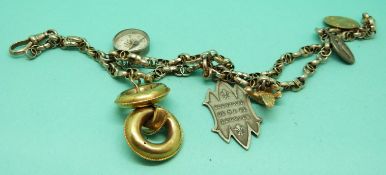 A Victorian bracelet made up of faceted links with charms including a compass and a Victorian