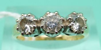 An 18ct gold ring set with three round brilliant cut diamonds, stamped Chard,