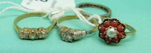 An 18ct gold ring set with a diamond in a platinum setting,