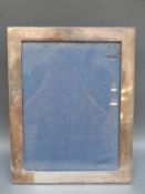A large hallmarked silver photograph frame for 9x12