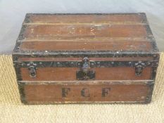 A Louis Vuitton ash and metal bound trunk with steel rollers, twin handles and lift out tray.