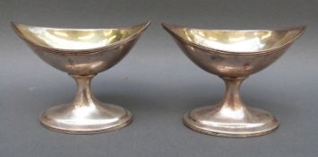 A pair of Georgian Irish hallmarked silver boat shaped pedestal salts with gilt wash interior,