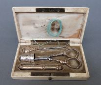 A 19thC ivory cased necessaire, the contents with yellow metal mounts and hallmarked silver thimble,