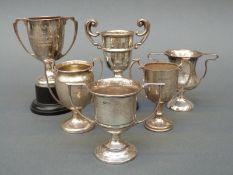 Six small or miniature hallmarked silver twin handled trophy cups, largest height 7.