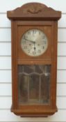 A c1910 two train wall clock with glass panelled door and Arabic silvered dial with spade hands