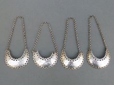 A set of four Hester Bateman hallmarked silver bottle labels or tickets of crescent design with