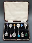 A cased set of six white metal and guilloche enamel teaspoons, marked sterling,