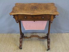 A Victorian burr walnut work table with drawer and pull out tray raised on carved legs,