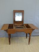 A 19th century campaign washstand having central fold up panel with hinged mirror flanked by two