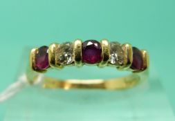 An 18ct gold ring set with alternating rubies and diamonds (Size K)