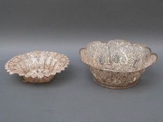 A white metal filigree basket with all over pierced floral decoration, 15cm diameter,