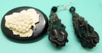 A pair of carved jet earrings in foliate design and a jet brooch set with an ivory carving of