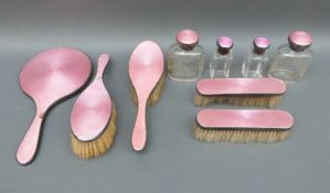 A hallmarked silver and guilloche enamel dressing table set comprising hand mirror,