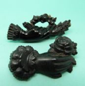 Two Victorian jet brooches in the form of hands and flowers.