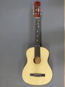 Child size acoustic guitar fitted with 6 nylon strings,
