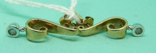 A pair of 9ct gold earrings in a scrolling design each set with a diamond, 2.8g.