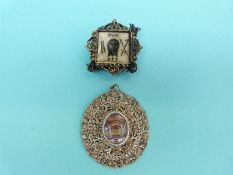 A white metal filigree pendant set with an Indian miniature and a white metal filigree icon