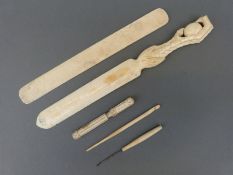 A 19thC ivory page turner with carved ball and claw finial, length 29.