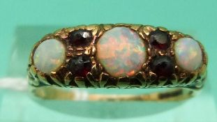 A 9ct gold ring set with opals and garnets (Size Q)